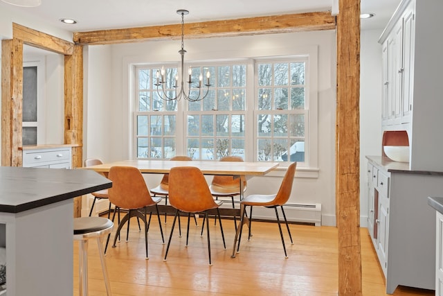 dining area with a wealth of natural light, light wood-type flooring, beamed ceiling, and a notable chandelier