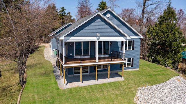 rear view of house with a lawn and a patio area