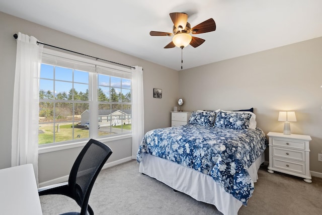 bedroom featuring baseboards, multiple windows, and carpet flooring