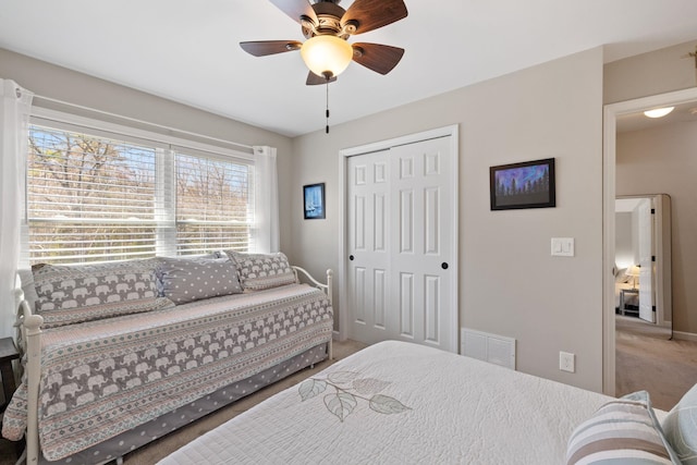 bedroom with carpet floors, multiple windows, a closet, and visible vents