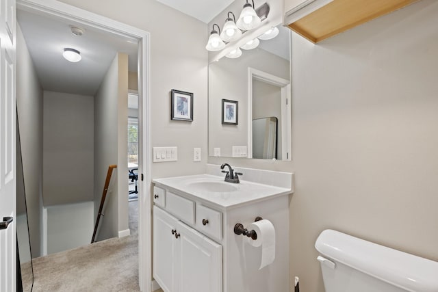 half bathroom with toilet and vanity