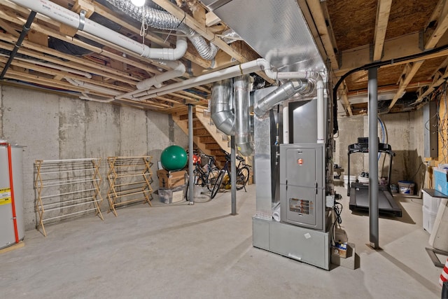 unfinished basement featuring heating unit and gas water heater
