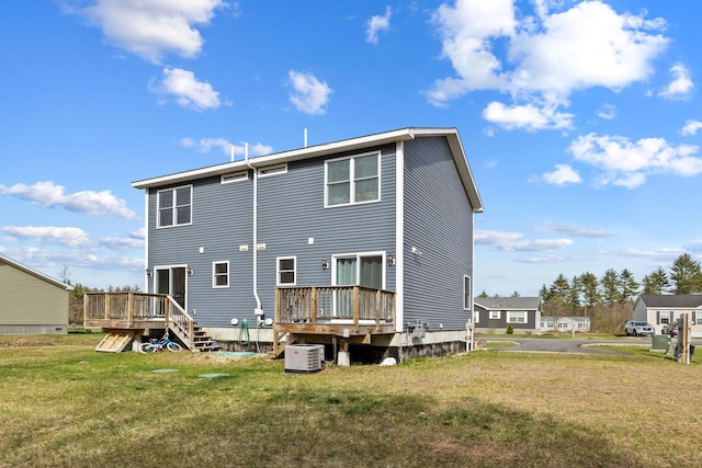 back of property featuring central air condition unit, a yard, and a deck