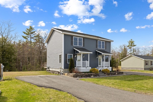 view of front of house with a front lawn and driveway
