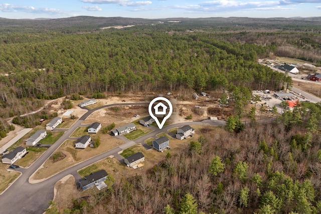 birds eye view of property featuring a view of trees