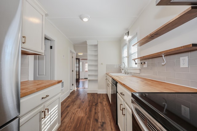 kitchen featuring open shelves, freestanding refrigerator, butcher block countertops, dark wood-type flooring, and backsplash