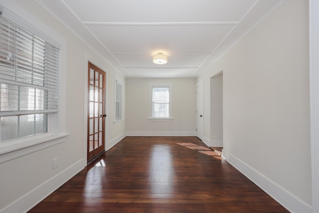 empty room with baseboards and hardwood / wood-style floors