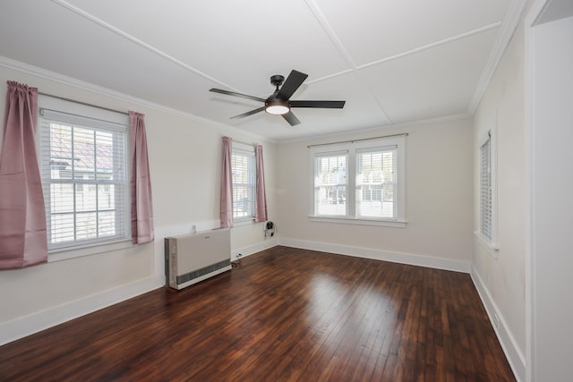 spare room with plenty of natural light, baseboards, crown molding, and hardwood / wood-style floors
