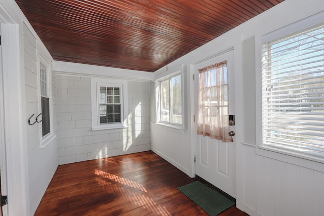 interior space featuring wooden ceiling, plenty of natural light, wood walls, and dark wood-style flooring