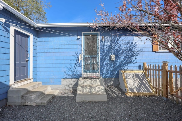 entrance to property featuring fence