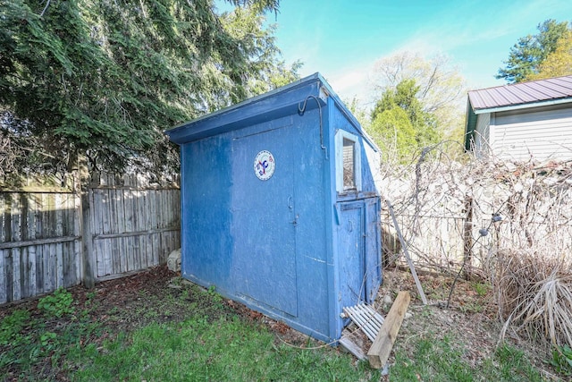 view of shed with fence