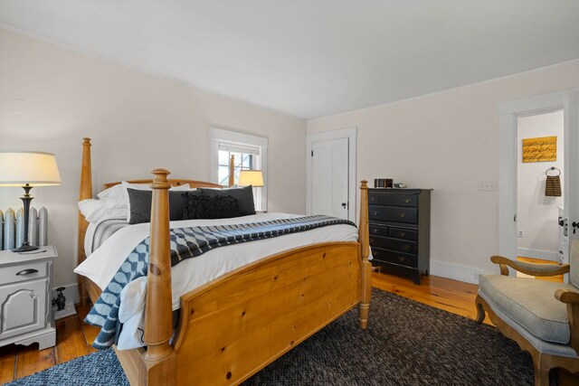 bedroom featuring baseboards and wood finished floors