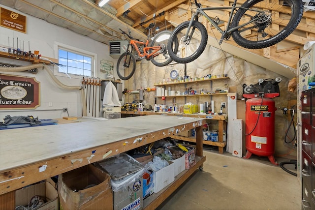 miscellaneous room with a workshop area and concrete floors