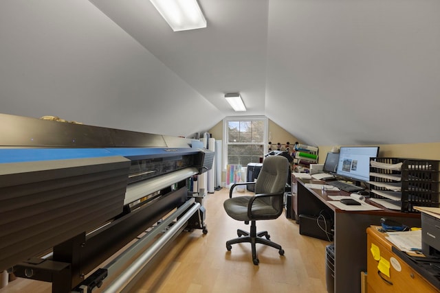 office area with vaulted ceiling and light wood-style floors