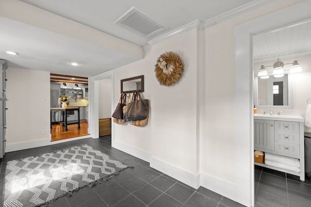 entrance foyer featuring recessed lighting, baseboards, dark tile patterned floors, visible vents, and ornamental molding