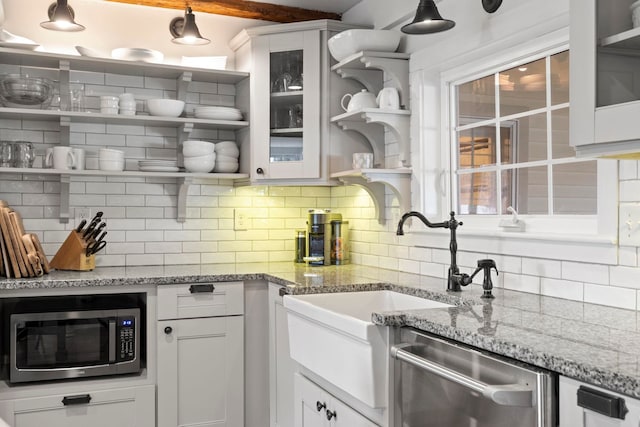 kitchen with white cabinets, open shelves, stainless steel appliances, backsplash, and glass insert cabinets