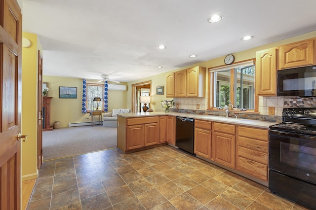 kitchen featuring a sink, recessed lighting, open floor plan, a baseboard radiator, and black appliances