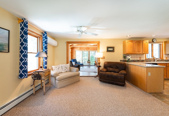 living area with a healthy amount of sunlight, baseboard heating, and a wall mounted air conditioner