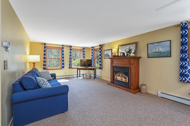 carpeted living area with a glass covered fireplace, baseboards, and a baseboard radiator