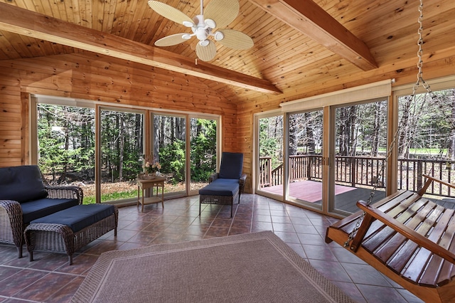 sunroom / solarium with ceiling fan and beam ceiling