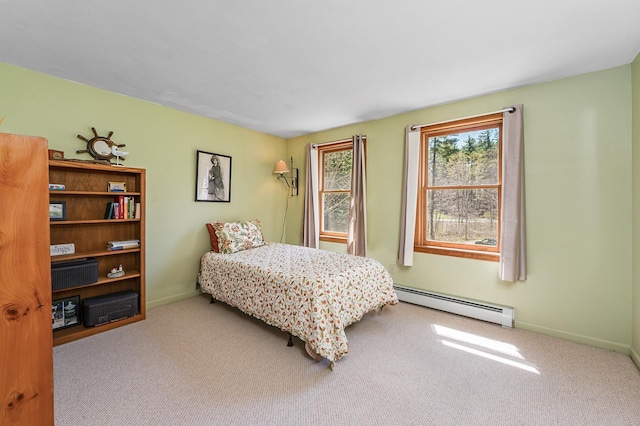 carpeted bedroom with baseboards and a baseboard radiator