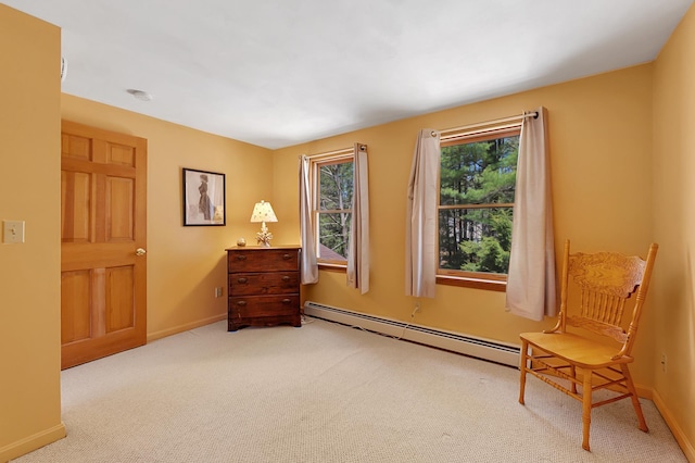 sitting room featuring baseboards, carpet flooring, and baseboard heating