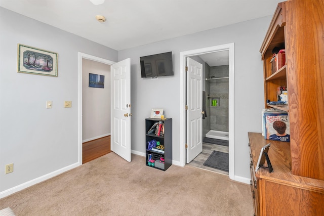 carpeted bedroom with baseboards and ensuite bathroom