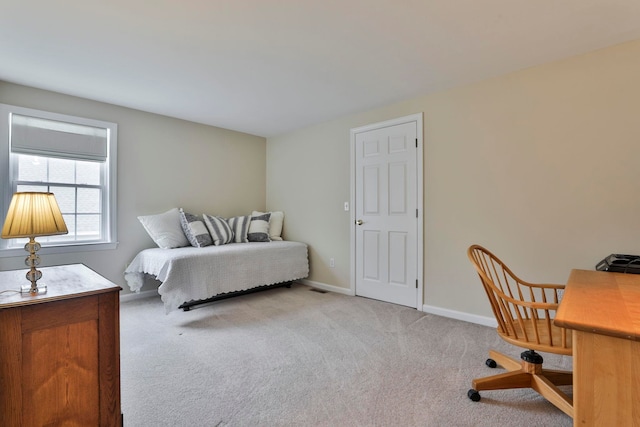 carpeted bedroom featuring baseboards