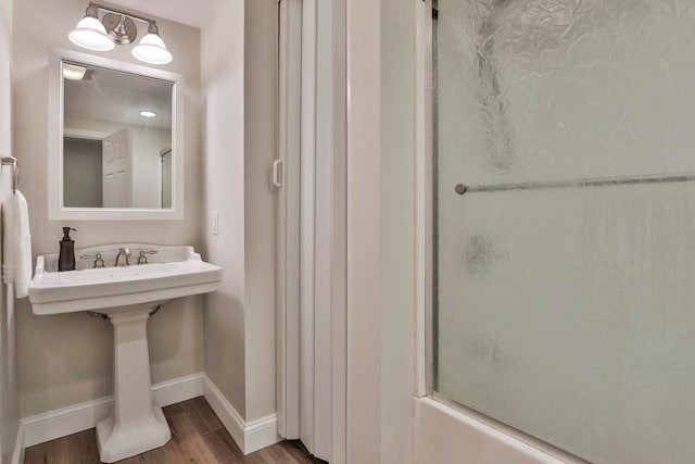bathroom with baseboards and wood finished floors