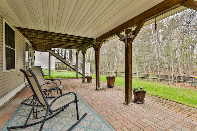 view of patio / terrace featuring a fenced backyard and stairs