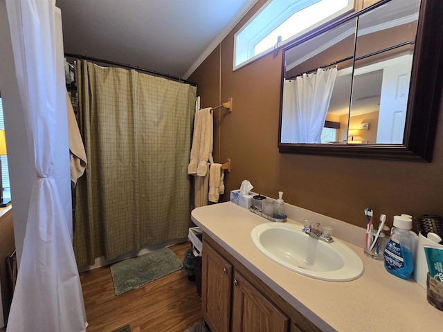 bathroom featuring vanity, ornamental molding, wood finished floors, and curtained shower