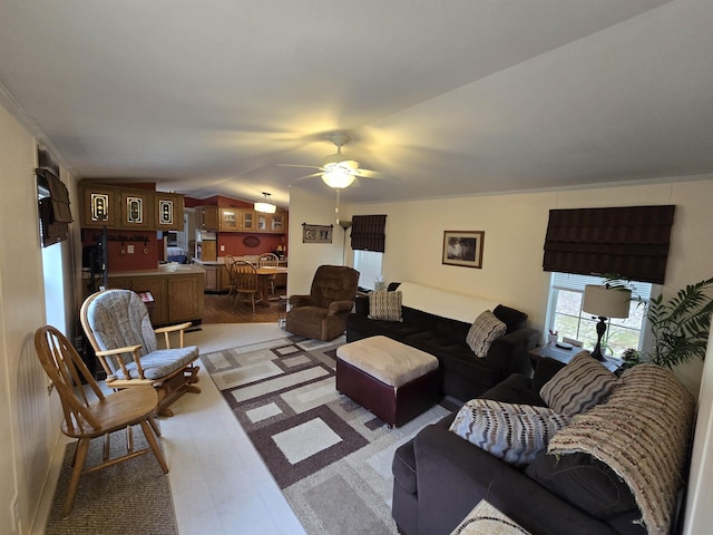 living area with light floors, a ceiling fan, and lofted ceiling