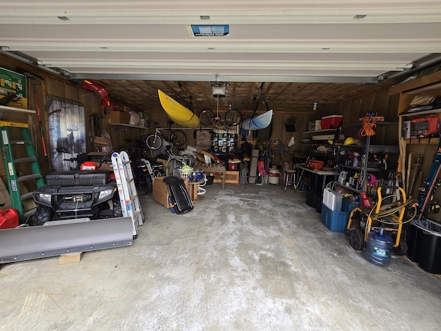 garage featuring a garage door opener and a workshop area