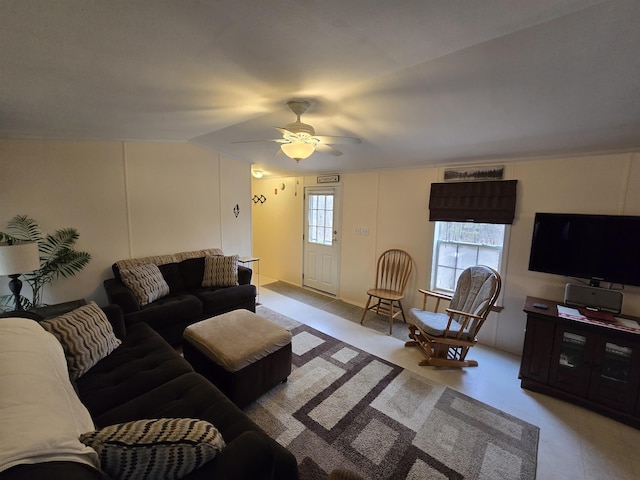 living room featuring ceiling fan and lofted ceiling