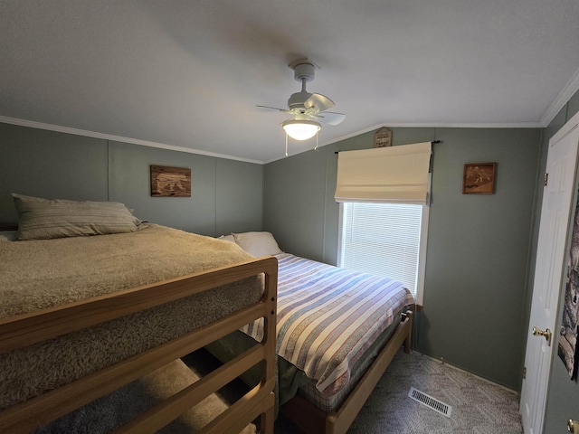 carpeted bedroom featuring crown molding, a ceiling fan, vaulted ceiling, and visible vents