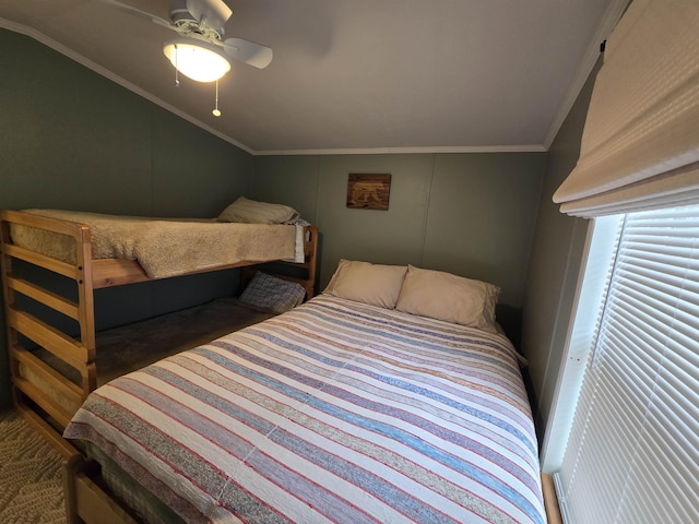 carpeted bedroom featuring ornamental molding, ceiling fan, and lofted ceiling