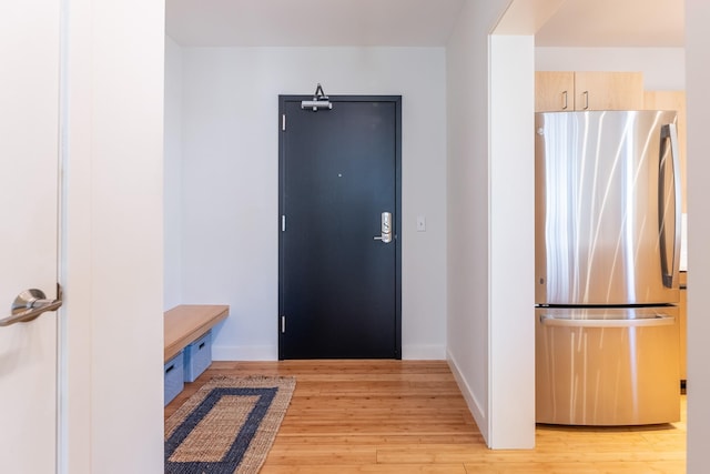 interior space featuring light wood-style floors and baseboards