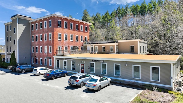 view of property featuring uncovered parking