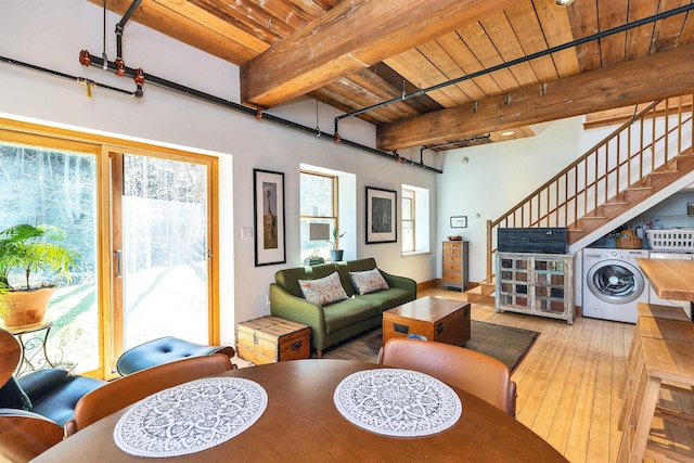 dining area featuring washer / dryer, hardwood / wood-style floors, beamed ceiling, stairway, and wood ceiling