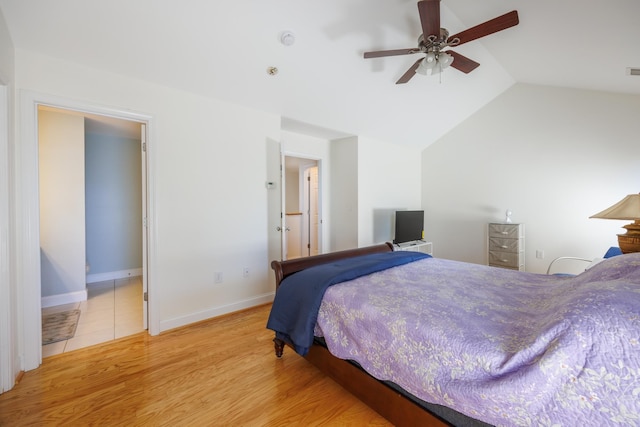 bedroom with baseboards, ceiling fan, wood finished floors, and lofted ceiling
