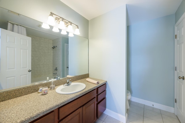 full bathroom with vanity, bathing tub / shower combination, toilet, baseboards, and tile patterned floors