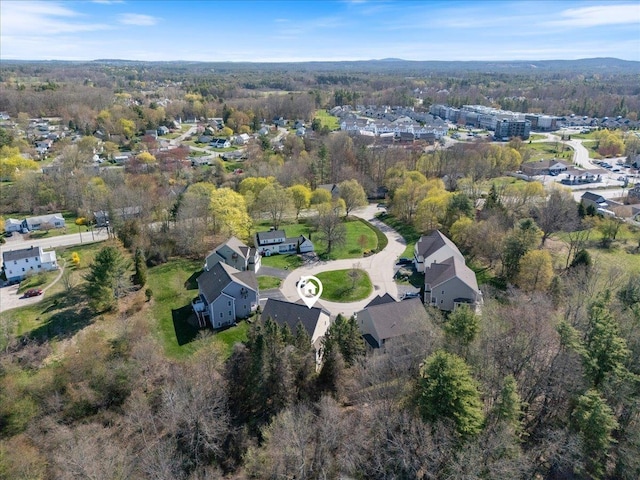 birds eye view of property with a wooded view