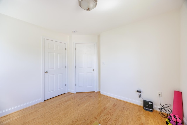 unfurnished bedroom with baseboards and light wood finished floors