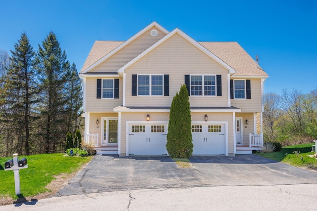 townhome / multi-family property with a garage, a front lawn, aphalt driveway, and a shingled roof