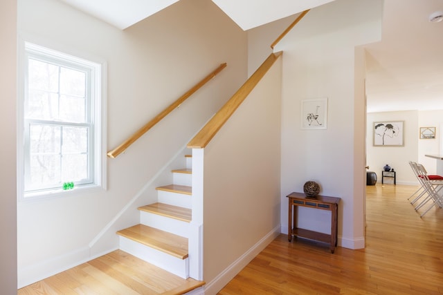 stairway featuring baseboards and wood finished floors