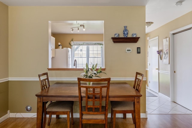 dining space featuring baseboards and wood finished floors