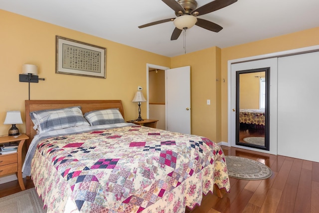 bedroom with a ceiling fan, wood finished floors, and a closet