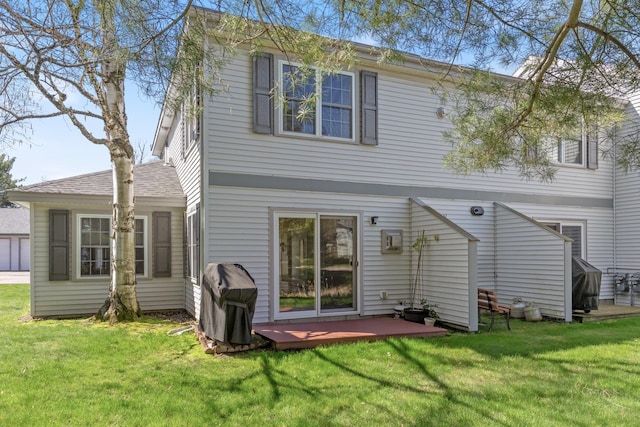 back of property with a yard and a deck