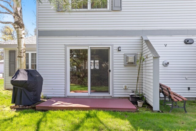 back of house featuring a yard and a wooden deck