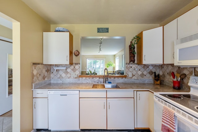 kitchen with white appliances, light countertops, white cabinetry, a sink, and backsplash
